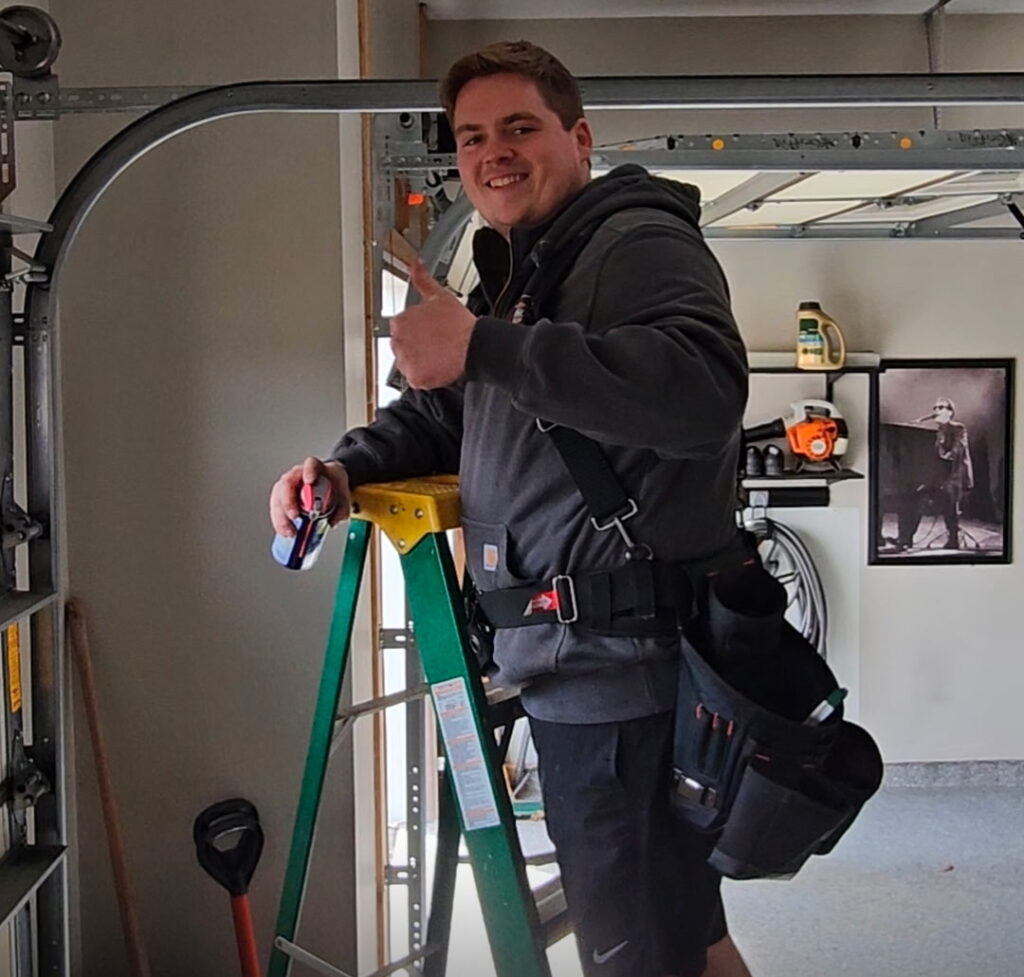 Matt fixing and tune-up garage doors for Topline Garage Doors in Blaine, MN